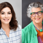 Nigella Lawson smiling in a promotional photo announcing her new role as Great British Bake Off judge
