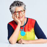 Prue Leith pictured at a public event, smiling in one of her signature colourful outfits