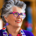Prue Leith smiling on the Great British Bake Off set shortly before announcing her departure from the show